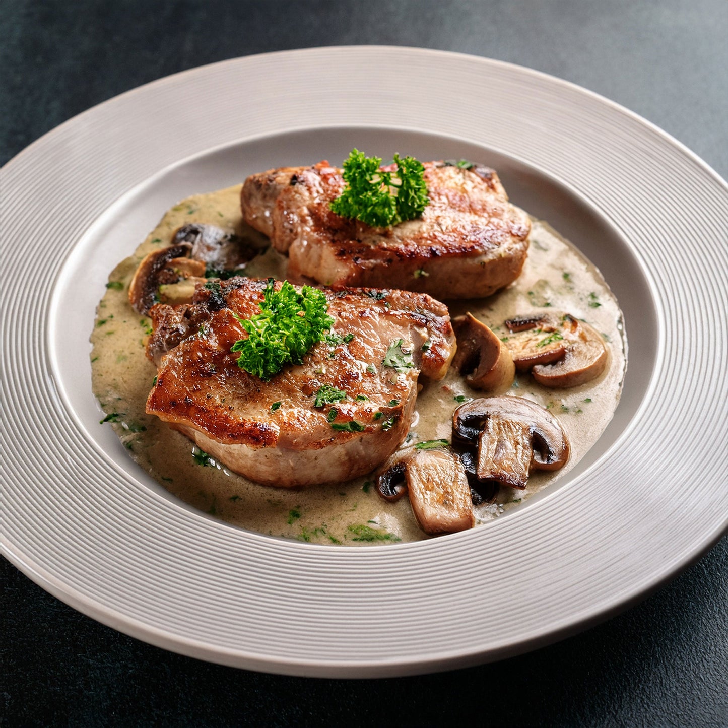 Seared pork chops with a creamy mushroom & herb sauce
